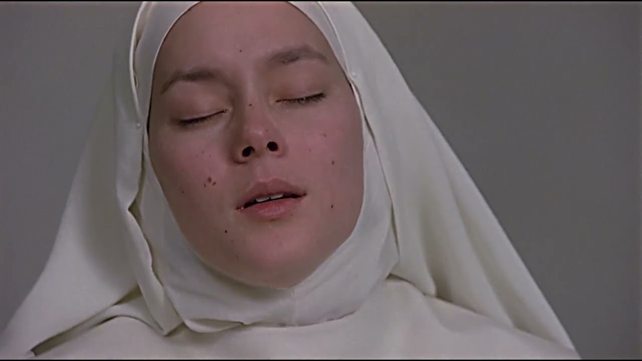 agnes from the 1985 film agnes of god with her eyes closed and head tilted back with an unreadable expression.