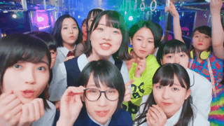 gif from a scene in beyooooonds' megane no otoko no ko mv - the members are in the train car during the short rap verse, jumping around chaotically and smiling in fun and confusion